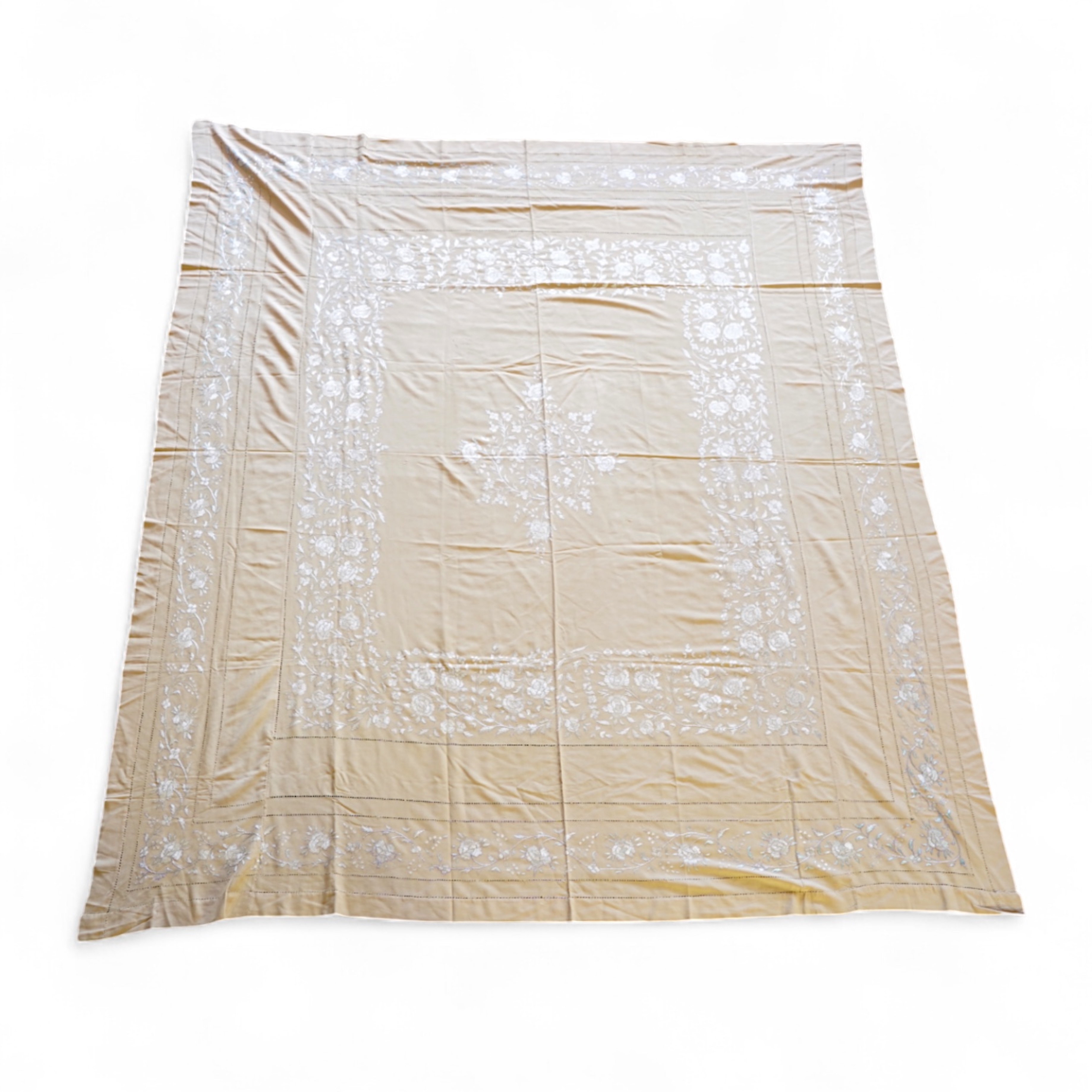A 1920’s heavy shantung silk hand embroidered table cover. Worked with decorative rows of button hole stitch. Embroidered with white, green and blue silk flowers. 240cm x 204cm. Condition - some fine holes near corners,